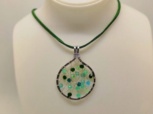 collier-femme-pendentif-de-4-cm en-fil-aluminium-argente-avec-perles-en-verre-de-différentes-tons-verts-tissés-au-centre-